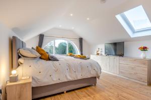a bedroom with a large bed and a tv at 1 Bed in Tasburgh oc-t28242 in Ashwellthorpe