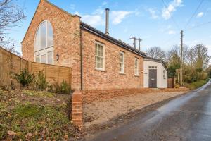 an old brick church with a brick driveway at 1 Bed in Tasburgh oc-t28242 in Ashwellthorpe