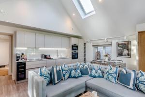 a living room with a gray couch with blue pillows at 2 Bed in Padstow oc-t29016 in Padstow