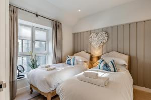 two beds in a room with a window at 2 Bed in Padstow oc-t29016 in Padstow