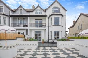 a large white house with a checkered floor at 6 Bed in Abersoch oc-c29569 in Abersoch