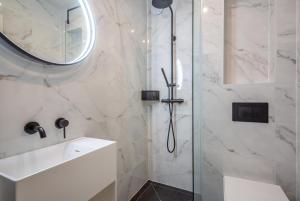 a bathroom with a shower with a sink and a mirror at 6 Bed in Abersoch oc-c29569 in Abersoch +31 photos