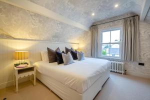 a bedroom with a white bed and a window at 6 Bed in Abersoch oc-c29569 in Abersoch