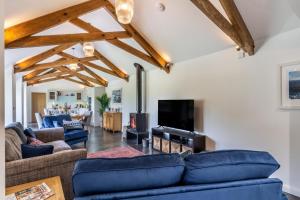a living room with blue couches and a tv at 3 Bed in Hartland oc-w29797 in Hartland