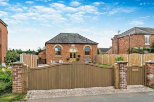 a wooden fence with a gate in front of a house at 1 Bed in Kinsham oc-t30051 in Kinsham