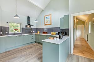 a kitchen with blue cabinets and a white counter top at 3 Bed in Loweswater oc-w30224 in Loweswater
