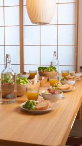 a wooden table with plates of food on it at 若葉ホテル in Tokyo