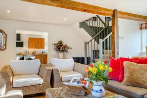 a living room with a couch and chairs and a staircase at 3 Bed in Chale oc-s30298 in Chale