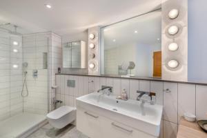 a bathroom with a sink and a toilet and a mirror at 4 Bed in Hythe oc-p30519 in Hythe +30 photos