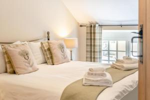 a bedroom with a bed with white sheets and pillows at 2 Bed in Trecastle oc-c30837 in Trecastle