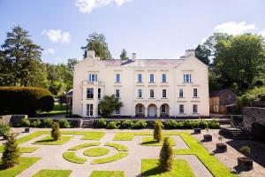 an exterior view of a large white house with a garden at 2 Bed in Trecastle oc-c30837 in Trecastle