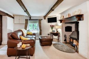 a living room with a leather couch and a fireplace at 2 Bed in Broadwoodkelly oc-j31818 in Broadwoodkelly