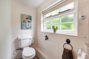 a white bathroom with a toilet and a window at 2 Bed in Broadwoodkelly oc-j31818 in Broadwoodkelly +13 photos