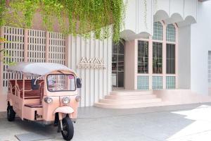 a pink scooter parked in front of a building at Away Bangkok Sukhumvit in Bangkok