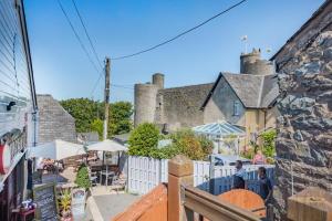 a group of people standing in front of a building at 1 Bed in Harlech oc-t32043 in Harlech