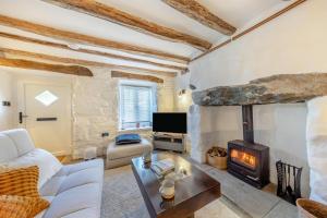 a living room with a white couch and a fireplace at 1 Bed in Harlech oc-t32043 in Harlech