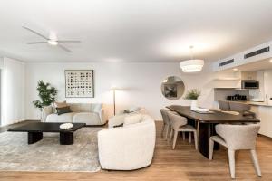 a living room and dining room with a table and chairs at Riverside Apartments & Hotel in Ballina