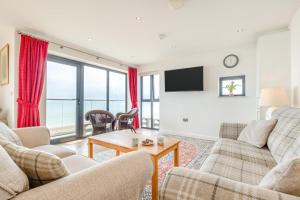 a living room with two couches and a table at 3 Bed in Hythe oc-s32090 in Hythe