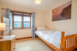 a bedroom with a bed and a window at 3 Bed in Woodford oc-w32062 in Kilkhampton