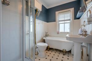a bathroom with a tub and a toilet and a sink at 2 Bed in Wimborne oc-s30924 in Wimborne Minster +18 photos