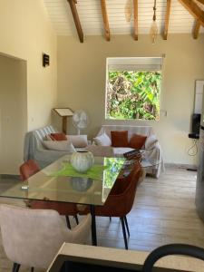 a living room with a table and a couch at Villa Surette in Capesterre