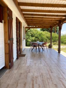 a porch with a table and chairs on it at Villa Surette in Capesterre
