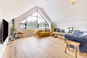 a living room with two couches and a large window at 5 Bed in Cyffylliog oc-c32596 in Cyffylliog