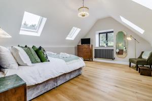 a white bedroom with a bed and a chair at 5 Bed in Cyffylliog oc-c32596 in Cyffylliog