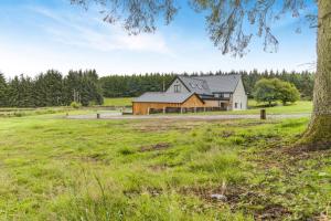 a large house in a field with a tree at 5 Bed in Cyffylliog oc-c32596 in Cyffylliog