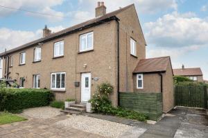 a brick house with a white door at 1 Bed in Seahouses oc-gd1735 in Seahouses +6 photos