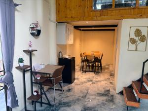 a dining room with a table and chairs at Sunray Hill in Ranong