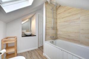 a bathroom with a white tub and a sink at 2 Bed in Crackington Haven oc-p00596 in Crackington Haven +10 photos