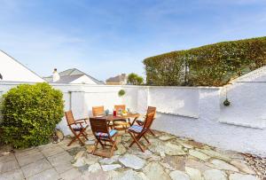 a patio with a table and chairs and a fence at 2 Bed in St. Ives oc-p00693 in Carbis Bay
