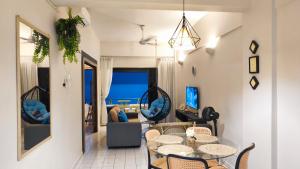 a living room with a table and chairs at SunsetSpa PD in Port Dickson