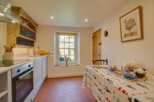 a kitchen with a table with a table cloth at 2 Bed in Docking oc-913 in Docking +8 photos