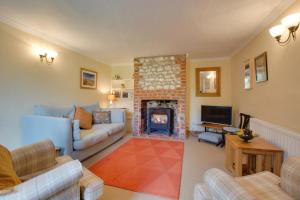 a living room with a couch and a fireplace at 2 Bed in Docking oc-913 in Docking