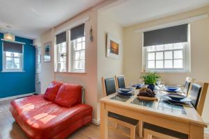 a dining room with a table and a red chair at 3 Bed in St. Ives oc-virg14 in St Ives
