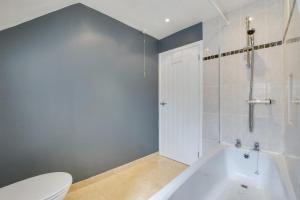 a bathroom with a white tub and a toilet at 3 Bed in St. Ives oc-virg14 in St Ives +10 photos