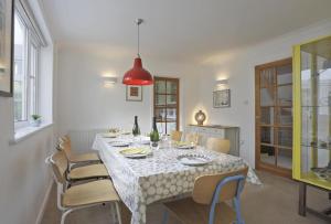 a dining room with a white table and chairs at 5 Bed in Walberswick oc-hferin in Walberswick
