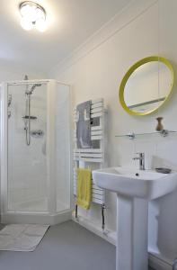 a white bathroom with a sink and a shower at 5 Bed in Walberswick oc-hferin in Walberswick +13 photos