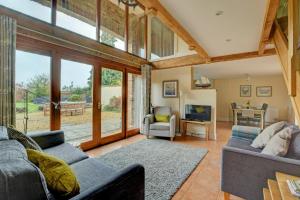 a living room with two couches and a television at 3 Bed in Thursford oc-1793 in Thursford