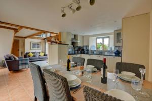 a dining room with a table and chairs and a kitchen at 3 Bed in Thursford oc-1793 in Thursford