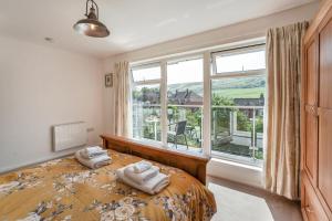 a bedroom with a bed and a large window at 3 Bed in West Lulworth oc-h29362 in West Lulworth