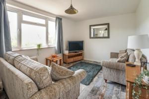 a living room with two couches and a television at 3 Bed in West Lulworth oc-h29362 in West Lulworth