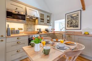 a kitchen with a wooden table with food on it at 1 Bed in Sarn oc-y29230 in Bottwnog