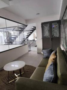 a living room with a couch and a table at Cozy corner in Gurgaon