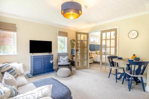 a living room with a blue cabinet and a table at 1 Bed in North Walsham oc-f29380 in North Walsham