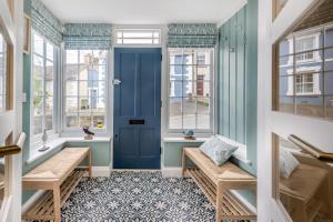a hallway with benches and windows and a blue door at 3 Bed in New Quay oc-c29640 in New Quay