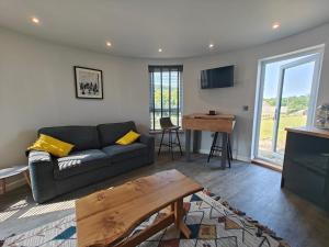 a living room with a couch and a table at 1 Bed in Creech oc-g29728 in Kimmeridge