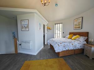 a bedroom with a bed with yellow pillows at 1 Bed in Creech oc-g29728 in Kimmeridge
